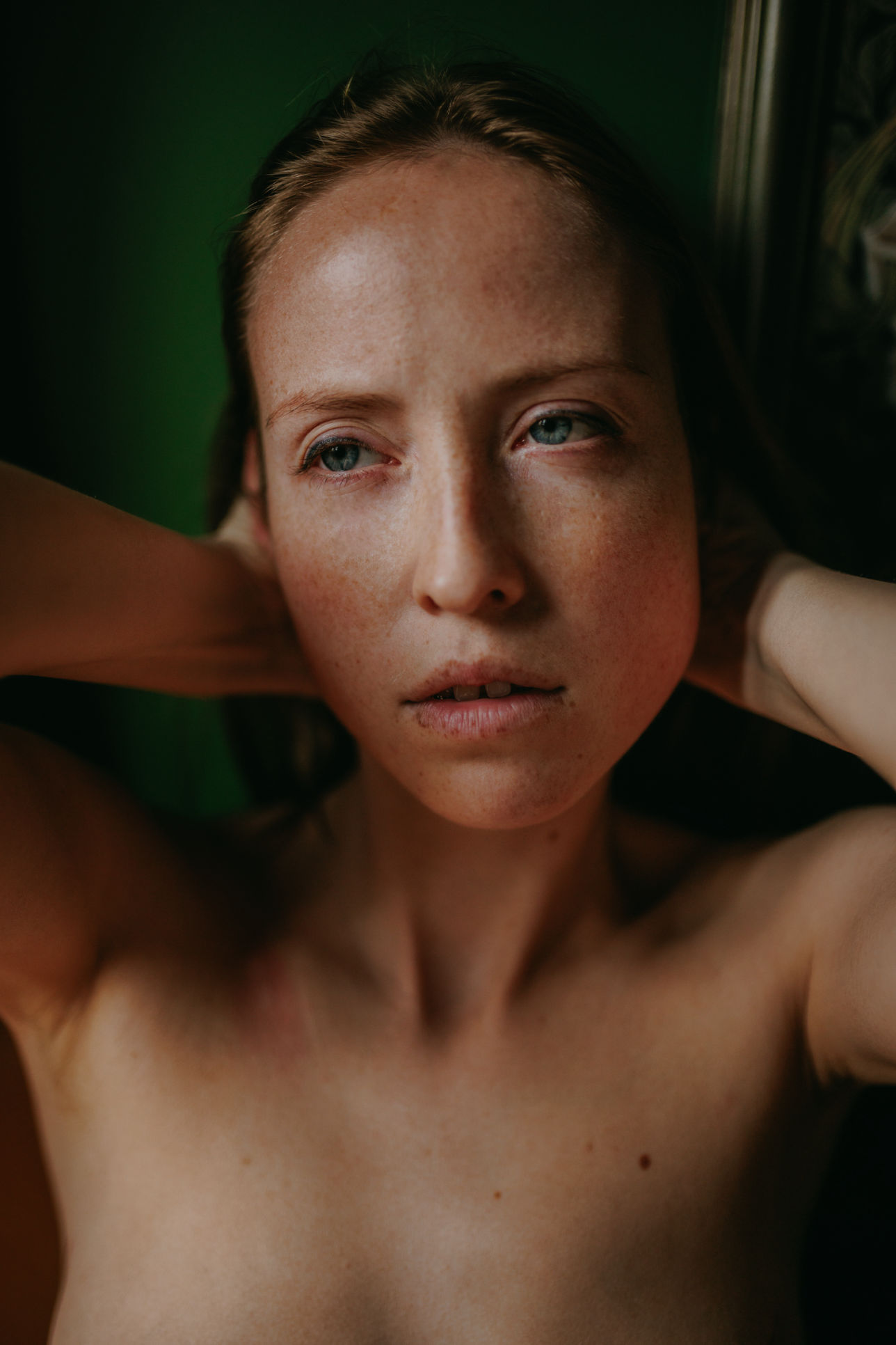 Iryna Berdnyk, editorial portrait in natural light, hands behind her head