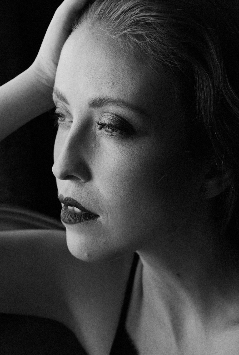 Iryna Berdnyk, black-and-white profile portrait in low light