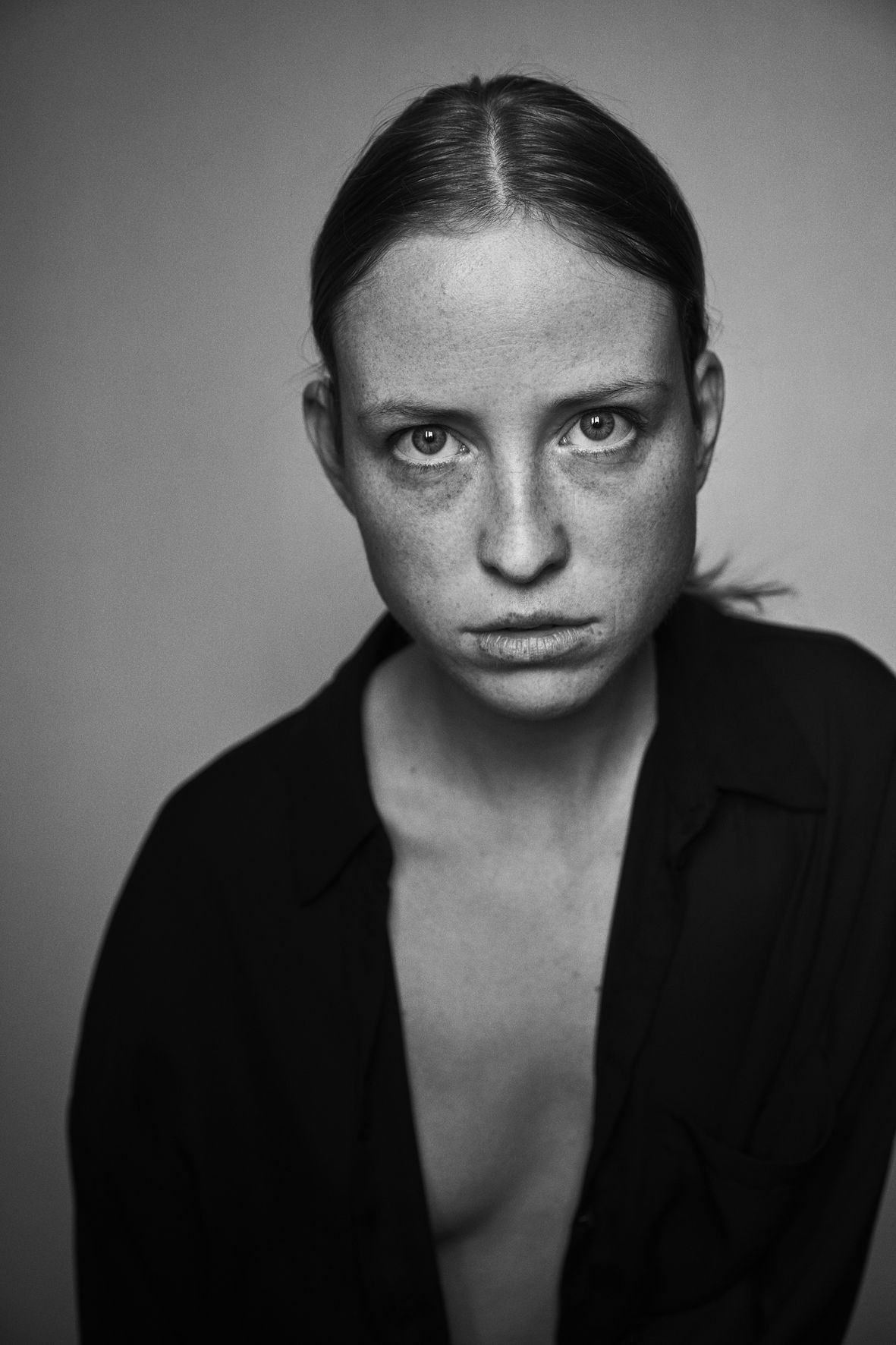 Iryna Berdnyk, black-and-white headshot in an open shirt